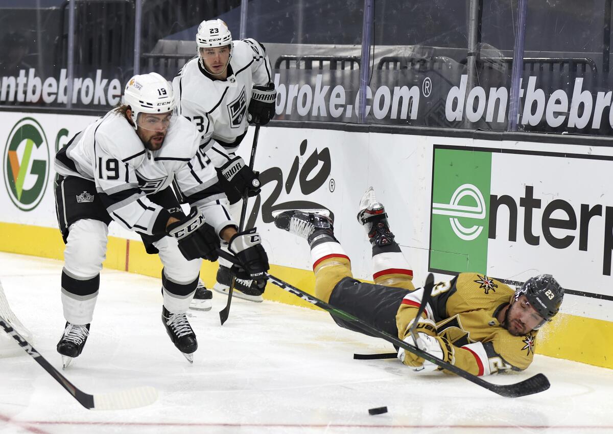 Kings center Alex Iafallo, left, and Vegas defenseman Alec Martinez battle for control of the puck Feb. 7 in Las Vegas.