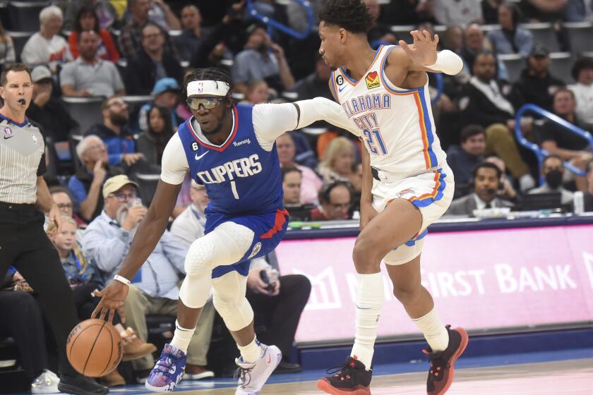 Los Angeles Clippers guard Reggie Jackson (1) pushes past Oklahoma City Thunder forward Aaron Wiggins (21) in the second half of an NBA basketball game, Thursday, Oct. 27, 2022, in Oklahoma City. (AP Photo/Kyle Phillips)