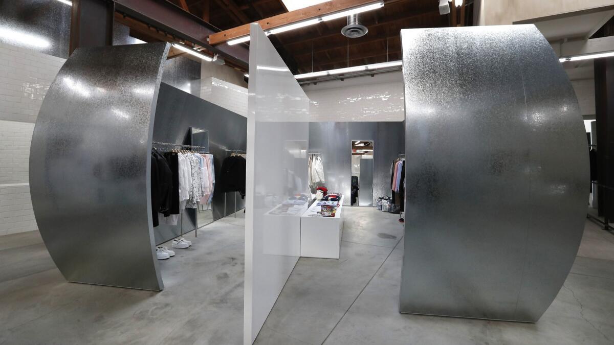 Curved walls of galvanized metal flank the Comme des Garçons Homme Plus and Shirt space inside the new Dover Street Market Los Angeles.