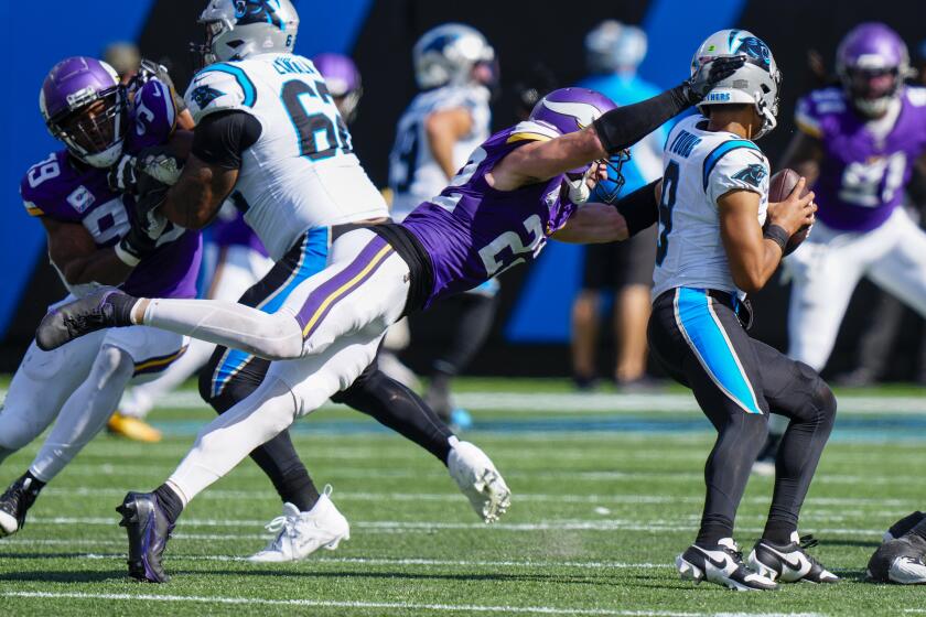 Carolina Panthers quarterback Bryce Young is sacked by Minnesota Vikings safety Harrison Smith during the second half of an NFL football game Sunday, Oct. 1, 2023, in Charlotte, N.C. (AP Photo/Jacob Kupferman)