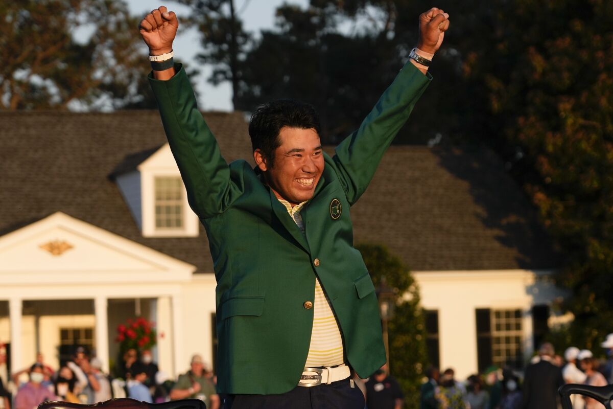 FILE - In this April 11, 2021, file photo, Hideki Matsuyama, of Japan, celebrates during champion's green jacket ceremony after winning the Masters golf tournament in Augusta, Ga. Matsuyama is among the favorites to win a gold medal in golf at the Olympics, all because of his green jacket. Matsuyama became the first Japanese player to win the Masters, a source of pride for a country with the greatest golf heritage of all Asian nations. (AP Photo/David J. Phillip, File)