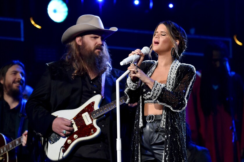 Chris Stapleton and Maren Morris performing together onstage