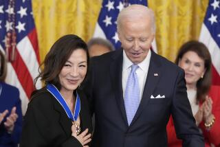 President Joe Biden awards the nation's highest civilian honor, the Presidential Medal of Freedom, to Michelle Yeoh during a ceremony in the East Room of the White House, Friday, May 3, 2024, in Washington. (AP Photo/Alex Brandon)