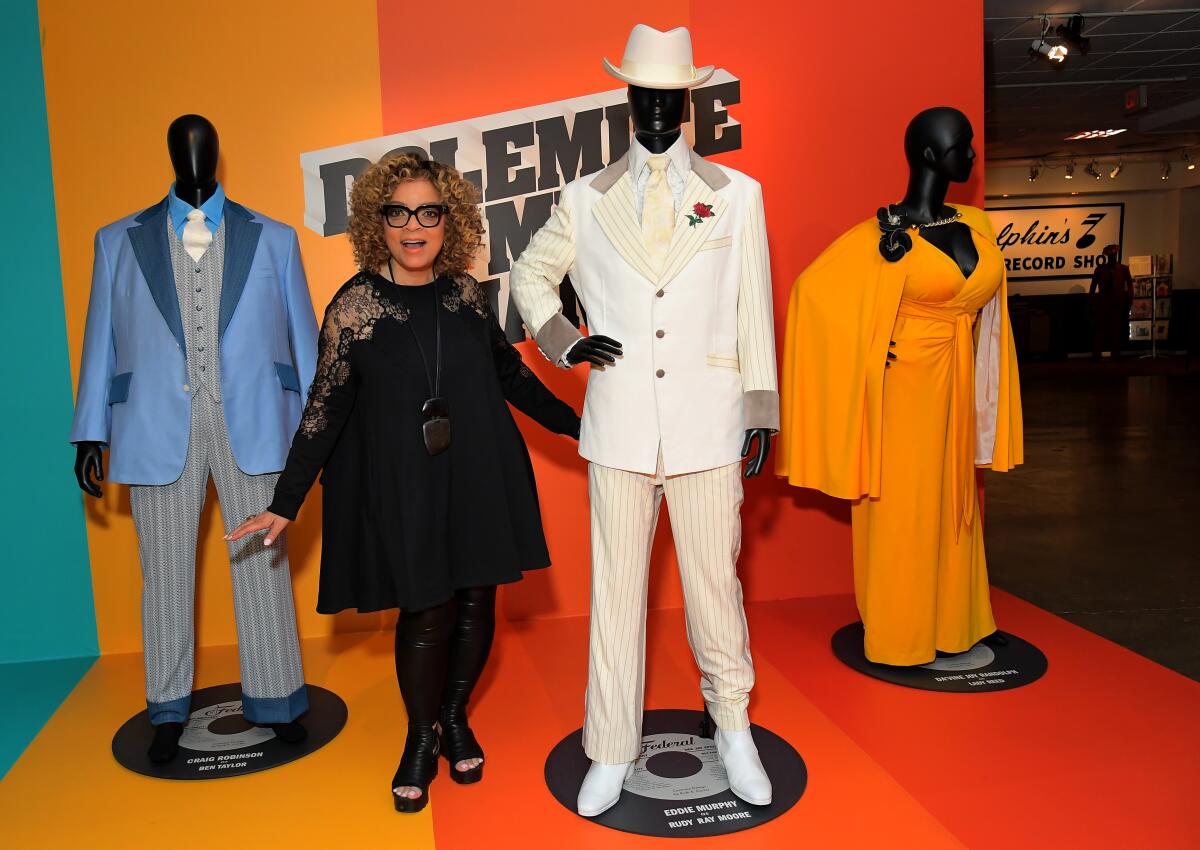 Costume designer Ruth E. Carter stands with her costumes from "Dolemite Is My Name"