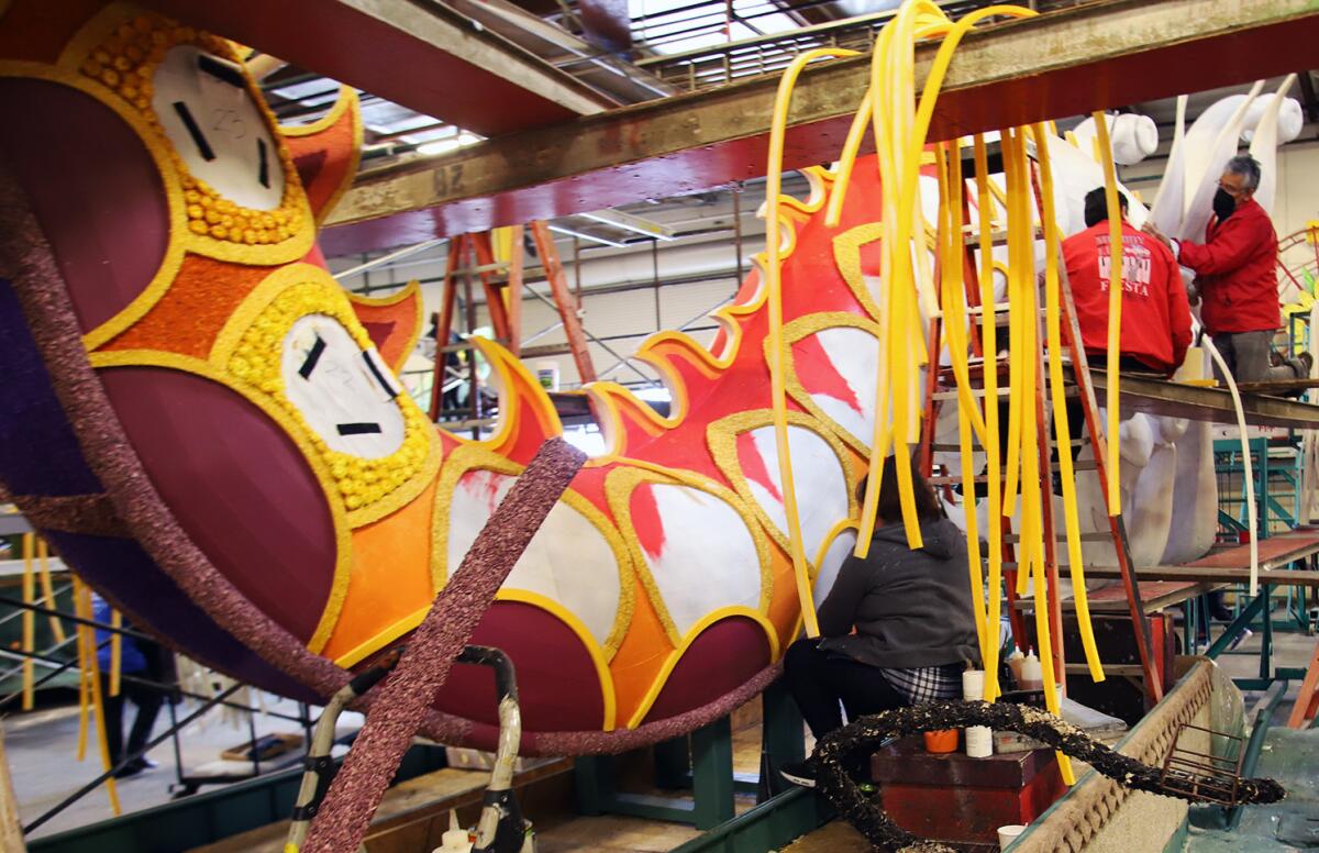 Workers from Fiesta Parade Floats work on the tail of a Chinese dragon for Donate Life's "Lifting Each Other Up."