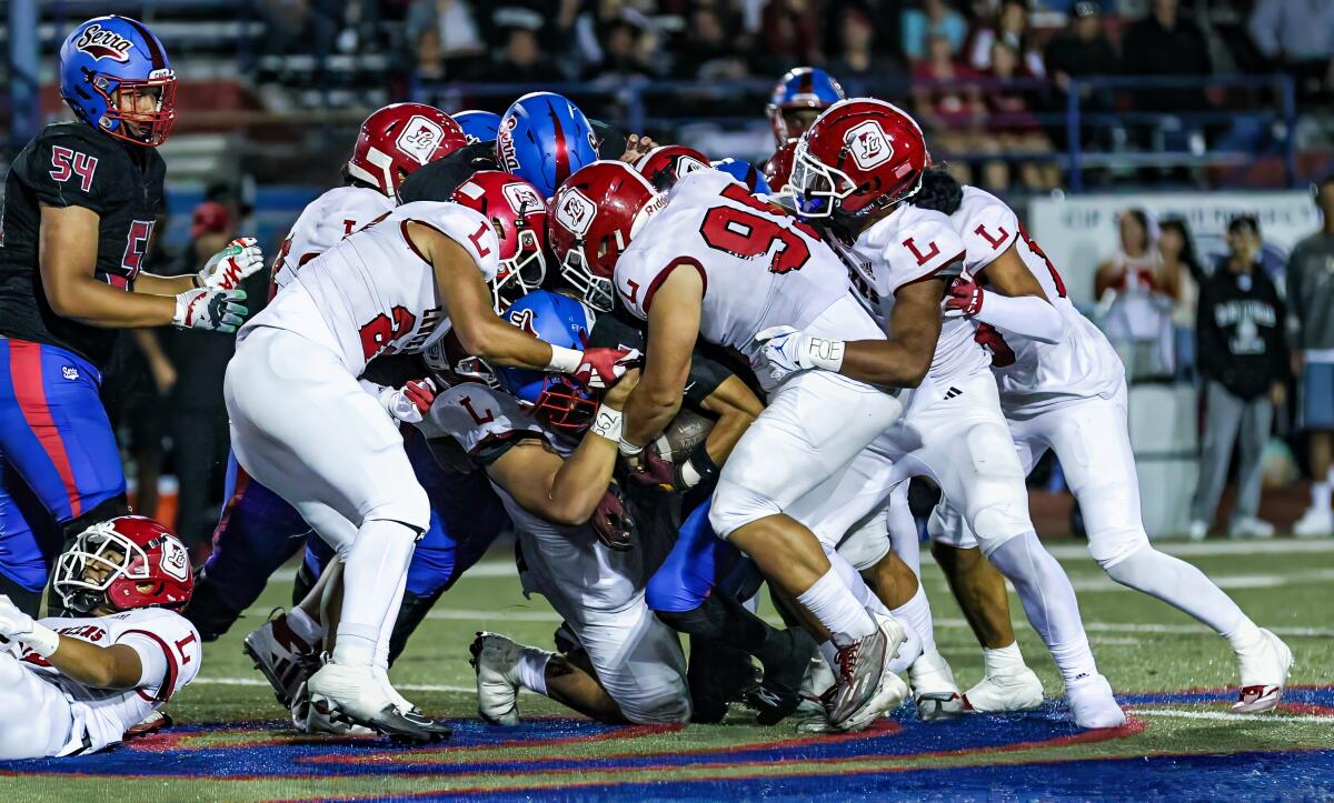 Orange Lutheran players swarm a Gardena Serra rusher.