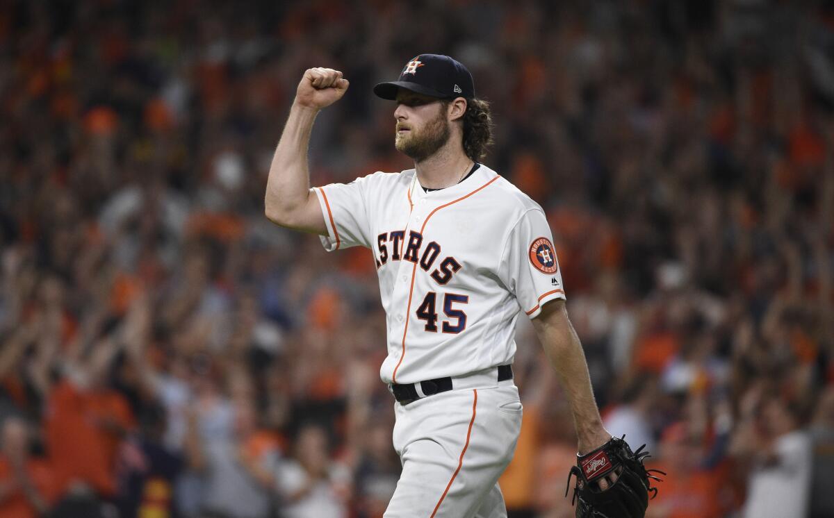 Houston Astros starting pitcher Gerrit Cole reacts to an out against the Tampa Bay Rays during the seventh inning of Game 5 of the ALDS in Houston on Thursday.