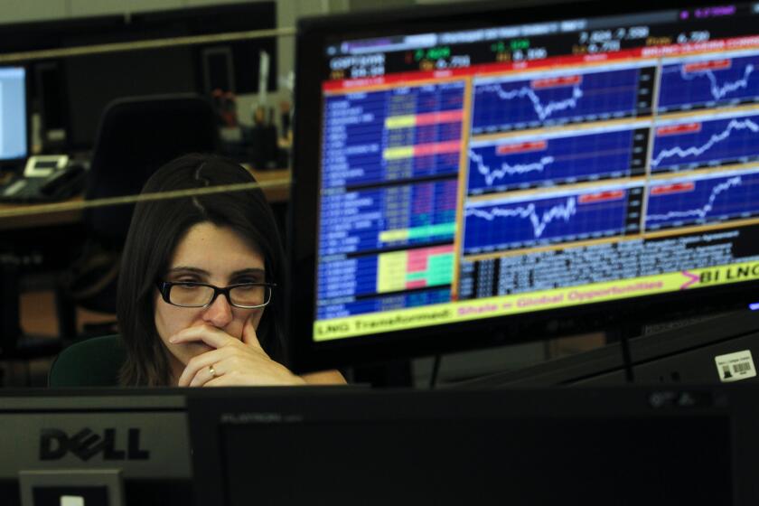 A broker works in a trading room of a Portuguese bank in Lisbon on Wednesday. The country's financial markets went into a steep nose dive during the day.