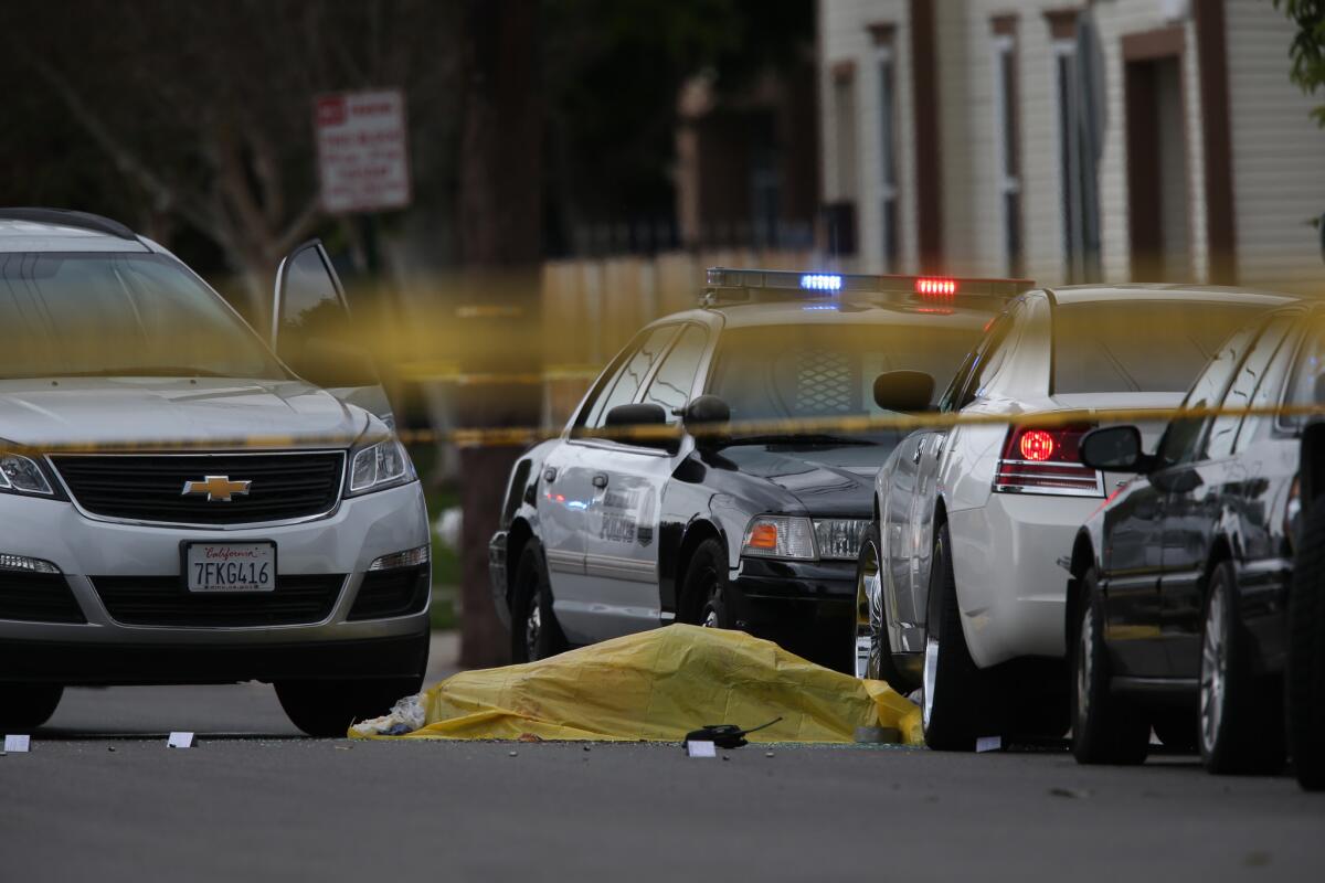 A body lies at the scene where two Santa Ana police officers were involved in a shooting that left one man dead in the 1000 block of West 3rd Street on Friday, Feb. 27.