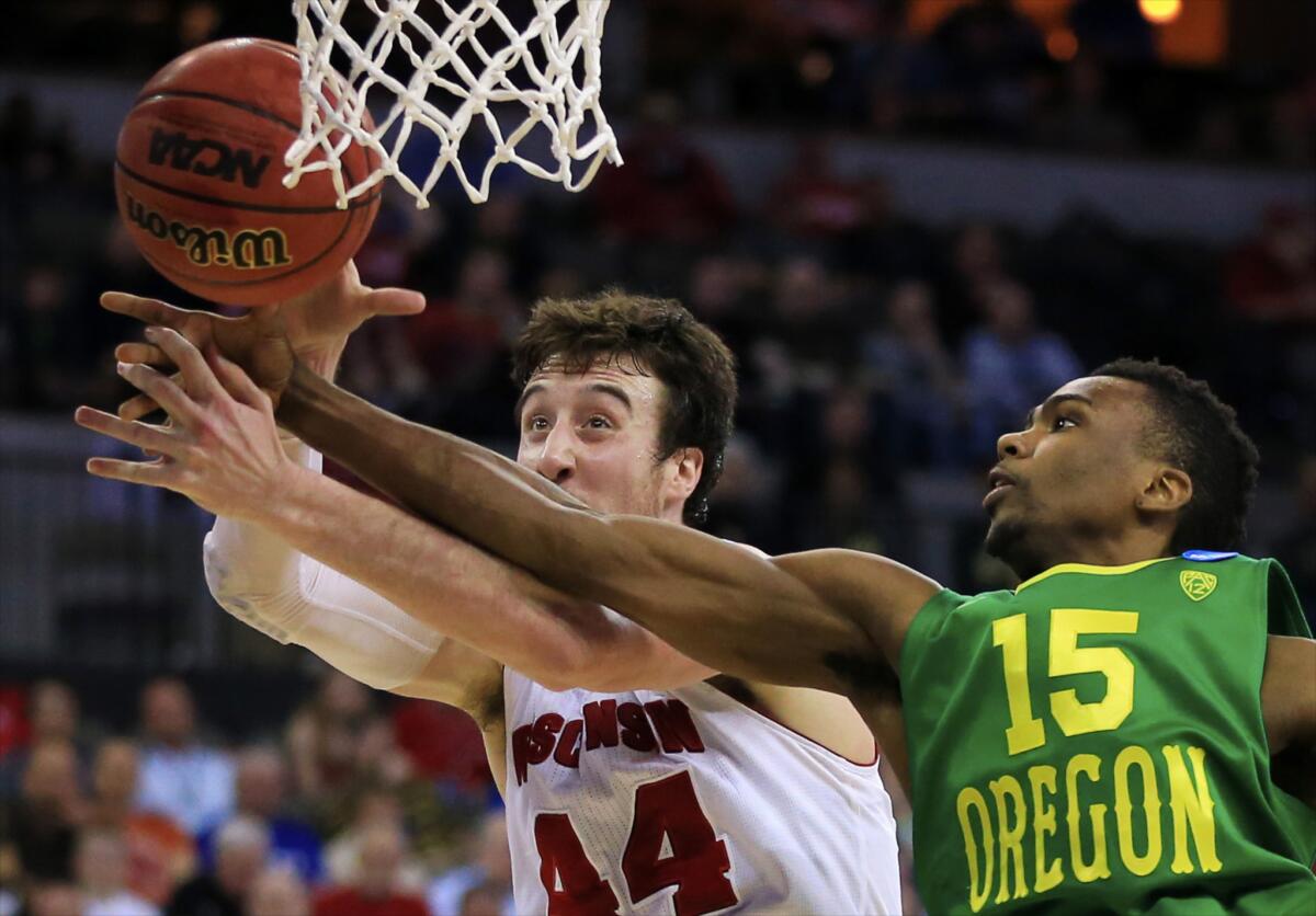 Wisconsin forward Frank Kaminsky (44) and Oregon guard Jalil Abdul-Bassit go for a rebound in the second half of the Badgers' 72-65 victory over the Ducks on Sunday.
