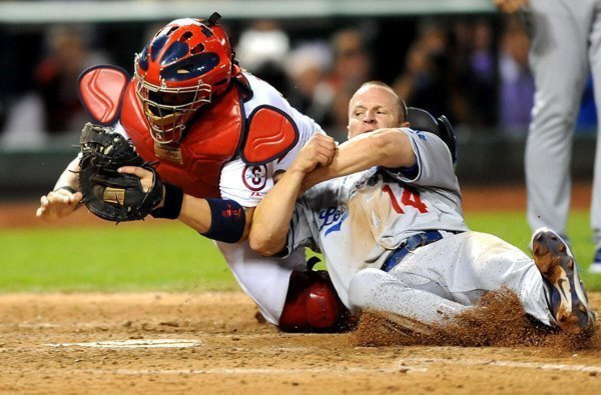 Dodgers second baseman Mark Ellis is tagged out at the plate by Cardinals catcher Yadier Molina after trying to score on a flyout by Michael Young in the 10th inning Friday night.