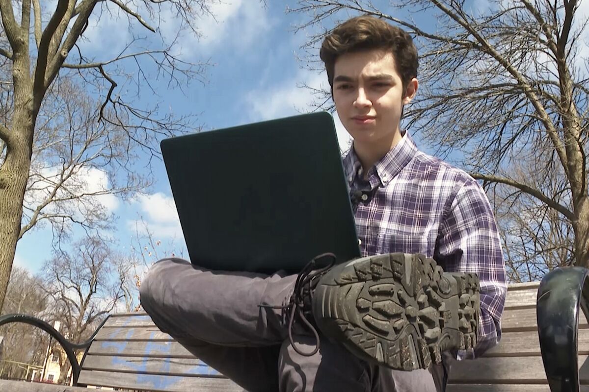 Harvard freshman Marco Burstein, 18, of Los Angeles, works on his computer near the campus of Harvard University in Cambridge, Mass., March 16, 2022. Moved by the plight of Ukrainian refugees desperate to escape Russian bombardment across the former Soviet republic, Burstein and classmate Avi Schiffman, of Seattle, used their coding skills to create UkraineTakeShelter.com over three frenzied days in early March. (AP Photo/Rodrique Ngowi)