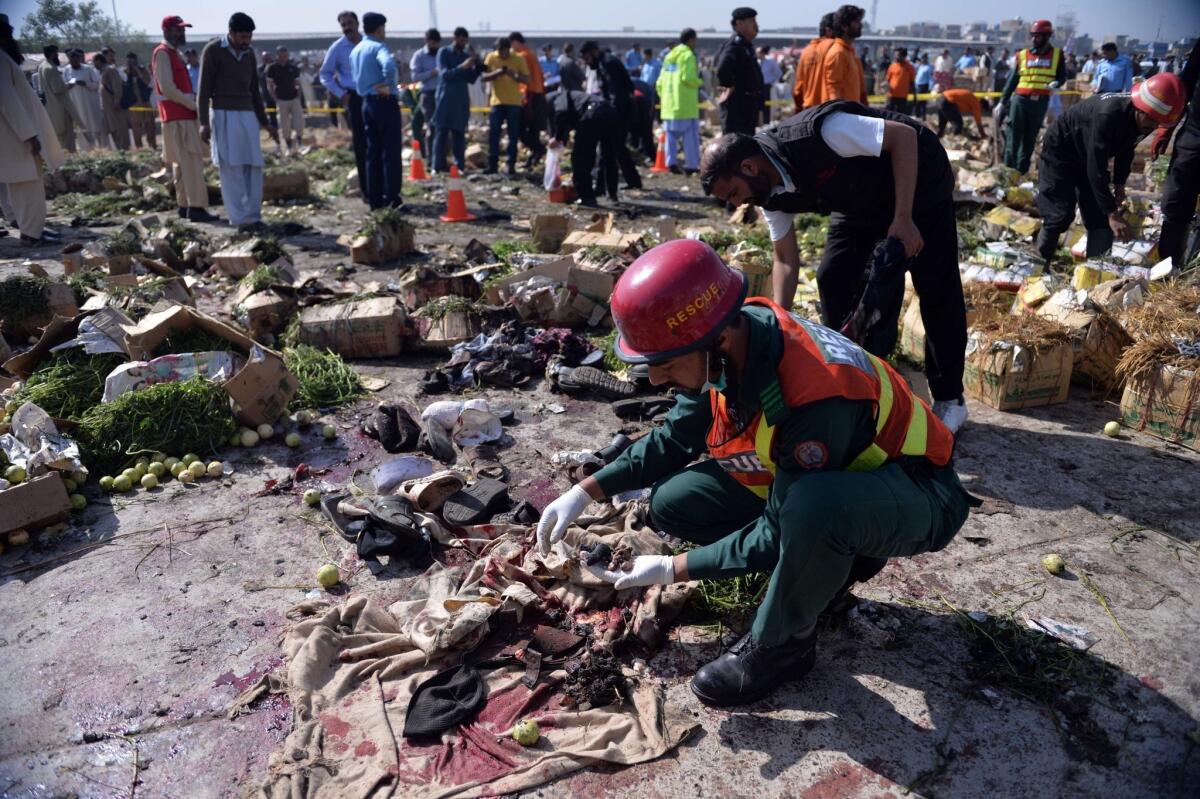 Volunteers collect the remains of victims of a powerful bomb in Islamabad's fruit and vegetable market.