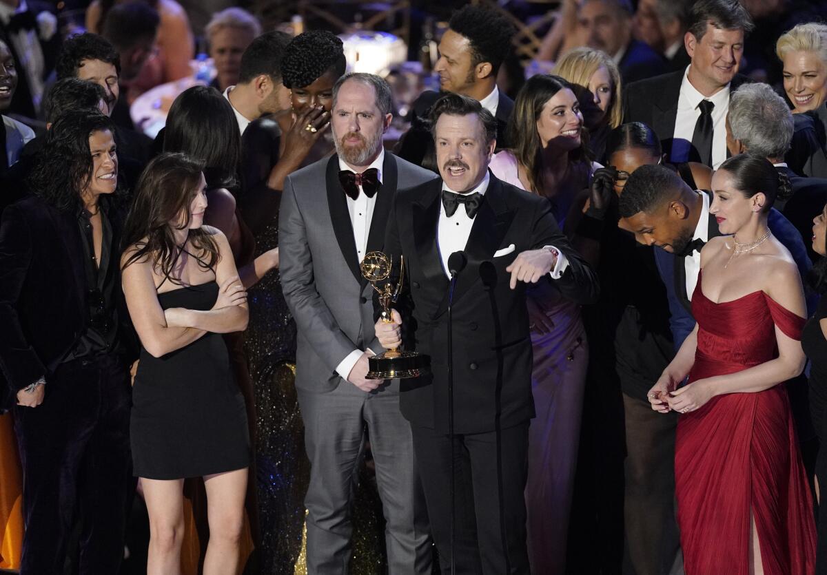 Jason Sudeikis, center, and the cast of "Ted Lasso" accept the Emmy for outstanding comedy series at the 74th Primetime Emmy Awards on Monday, Sept. 12, 2022, at the Microsoft Theater in Los Angeles. (AP Photo/Mark Terrill)