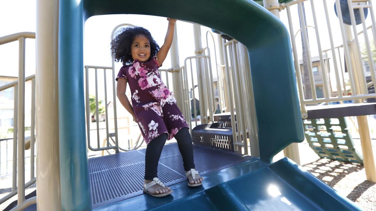 Maipele Burns, 4, prepares to go down the slide, while playing in the park across the street from her home in Camarillo. Maipele was diagnosed at age 2 with acute flaccid myelitis, causing permanent paralysis in her right arm.