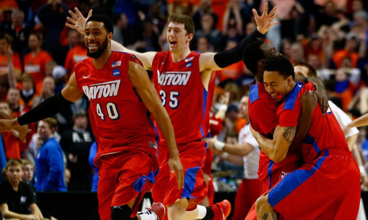 Dayton players celebrate their upset win over Syracuse in the third round of the NCAA tournament Saturday. Dayton isn't the only team that has defied expectations in its trek to the Sweet 16.
