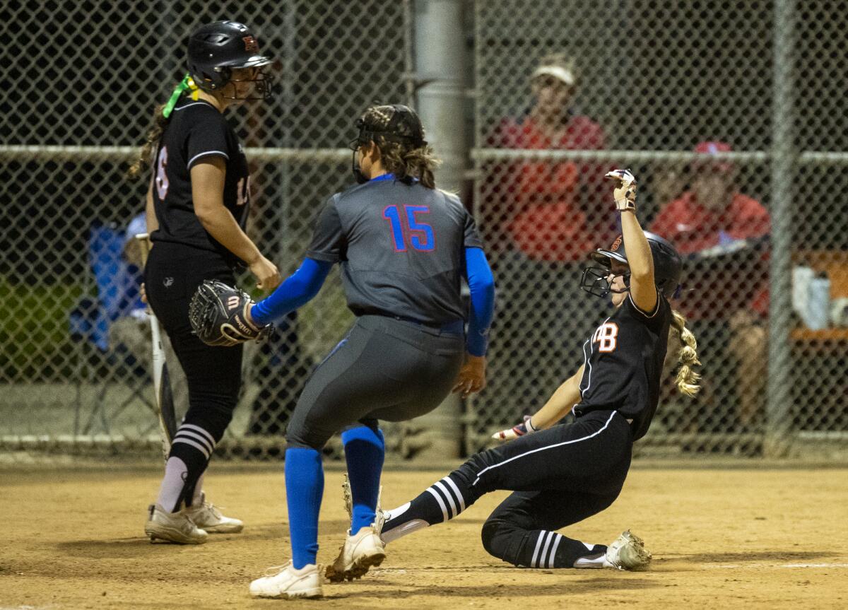 Huntington Beach's Sophia Knight scores on a passed ball in the fifth inning of a game against Los Alamitos on Tuesday.
