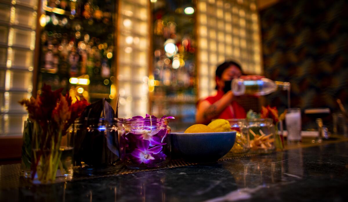 A woman works behind the bar at Pinky's. 