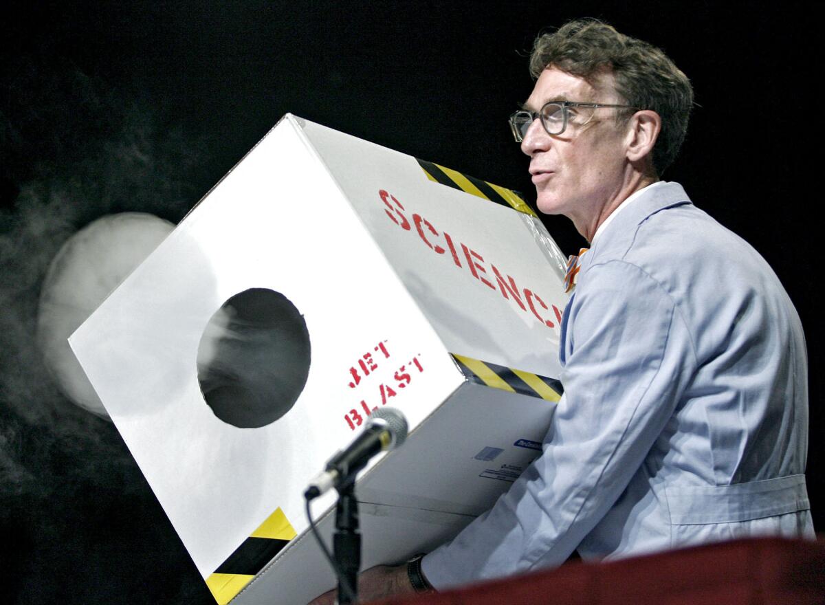 In this file photo, Bill Nye "The Science Guy" sends out a blast of smoke from a box during a presentation at the Planetary Society's PlanetFest at the Pasadena Convention Center on Saturday, Aug. 4, 2012.