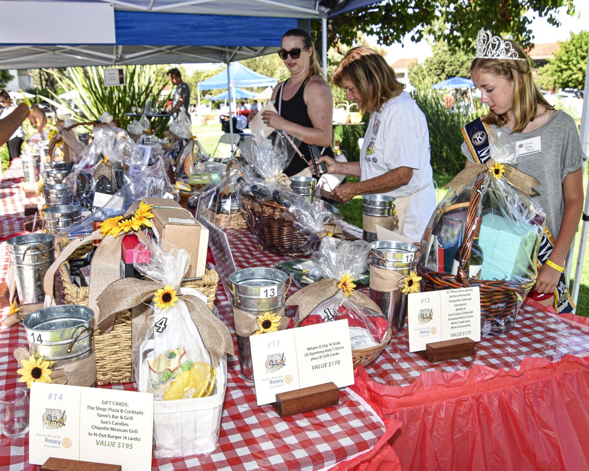 Volunteers organizing the table of raffle prizes. Many of the volunteers were the members of the Poway Princesses. Far left, Kayla Locher. Far right: Kate Terry.