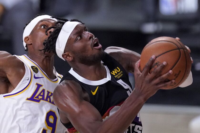 Denver Nuggets forward Jerami Grant (9) goes up for a shot in front of Los Angeles Lakers' Rajon Rondo, left, during the second half of Game 3 of the NBA basketball Western Conference final Tuesday, Sept. 22, 2020, in Lake Buena Vista, Fla. (AP Photo/Mark J. Terrill)