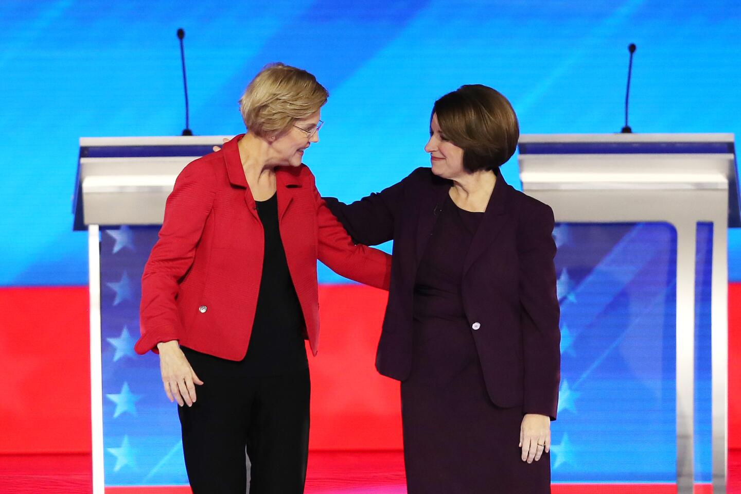Democratic presidential candidates Sen. Elizabeth Warren (D-Mass.), left, and Sen. Amy Klobuchar (D-Minn.) greet each prior to the start of the Democratic presidential primary debate at St. Anselm College on Friday in Manchester, N.H.