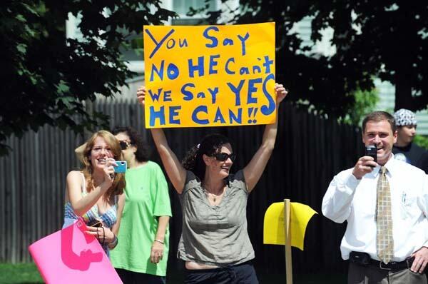 A woman holds up a sign in Portsmouth, New Hampshire