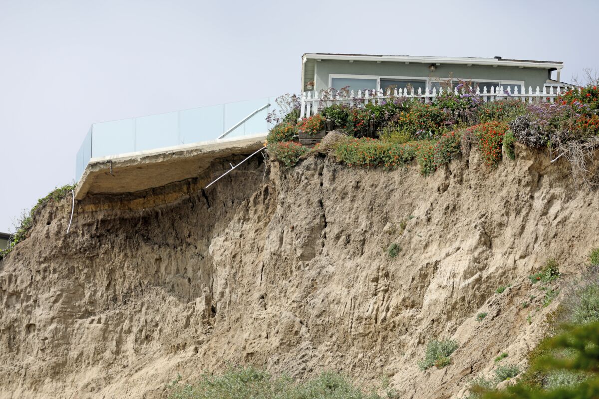 A bluff erodes beneath a beachfront home in Orange County.  