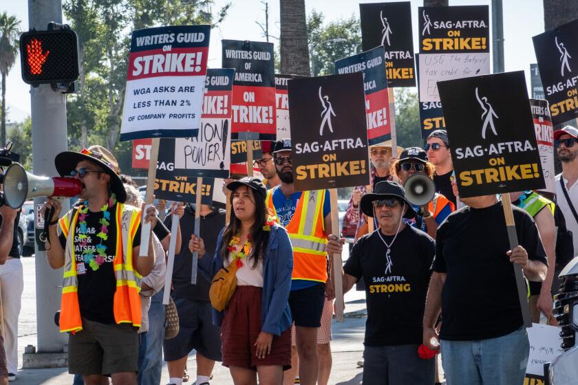 LOS ANGELES, CA - JULY 14: SAG-AFTRA members join the Writers Guild of America on the picket line outside Netflix in Los Angeles, CA on Friday, July 14, 2023. Actors join striking writers who have been on the picket lines since the beginning of May. (Myung J. Chun / Los Angeles Times)