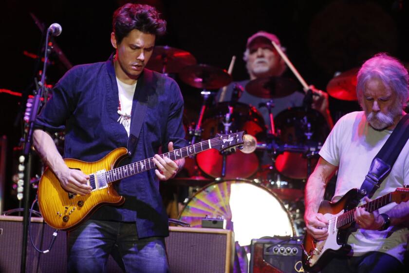 LOS ANGELES , CA-DECEMBER 30, 2015: Dead & Company, a new group pairing 3 members of the Grateful Dead, including original members Bob Weir, right, and Bill Kreutzmann, rear on drums, with singer-songwriter John Mayer played the first of two nights at the Forum on Wednesday. (Michael Robinson Chavez / Los Angeles Times)