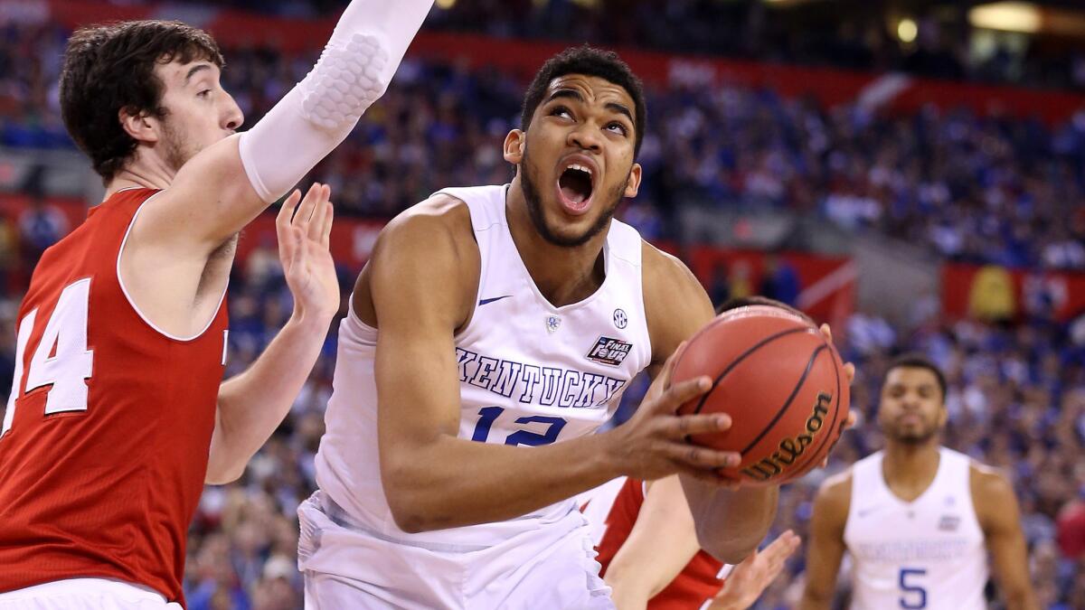 Kentucky's Karl-Anthony Towns, right, drives on Wisconsin's Frank Kaminsky during the NCAA semifinals on April 4, 2015. The Lakers are in a good spot to draft Towns.