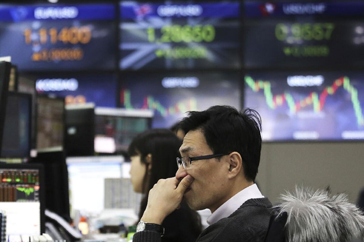 A currency trader at KEB Hana Bank headquarters in Seoul on Thursday.