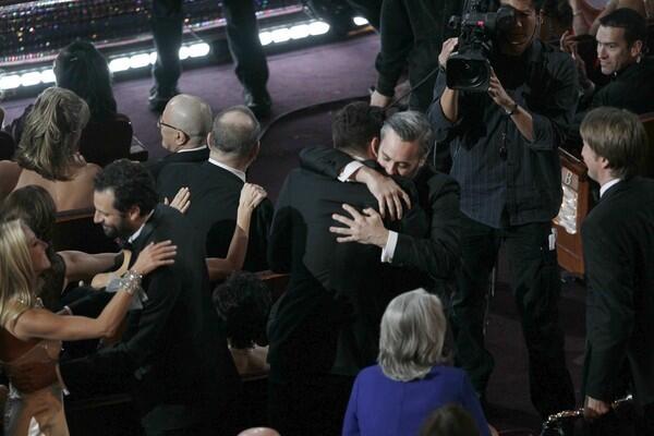 Audience members who were also "The King's Speech" supporters embrace after the film wins best picture.