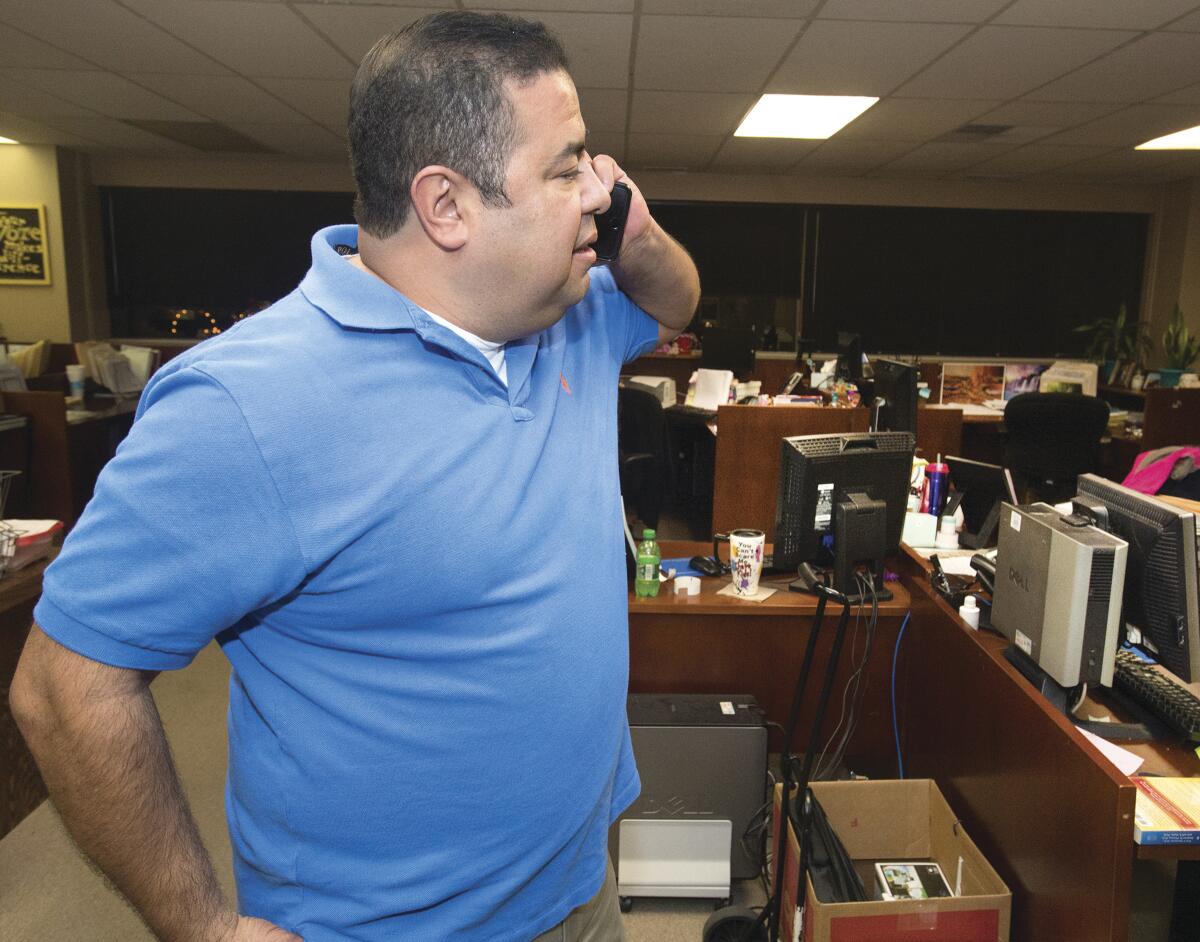 FILE - Gilbert Ortiz, Pueblo County's clerk and recorder, checks the status of voting machines that apparently failed to work correctly, causing long delays in election results being released, in Pueblo, Colo., on Nov, 8, 2016. On Thursday, Nov. 3, 2022, Richard Patton, 31, of Pueblo was arrested on suspicion of tampering with voting equipment by allegedly inserting a USB thumb drive into a voting machine at a polling station during the primary election in June, authorities said. Ortiz confirmed Friday, Nov. 4, that Patton has been a registered Democratic voter since 2019, when he switched his affiliation from the Green Party. (Chris McLean/The Pueblo Chieftain via AP, File)
