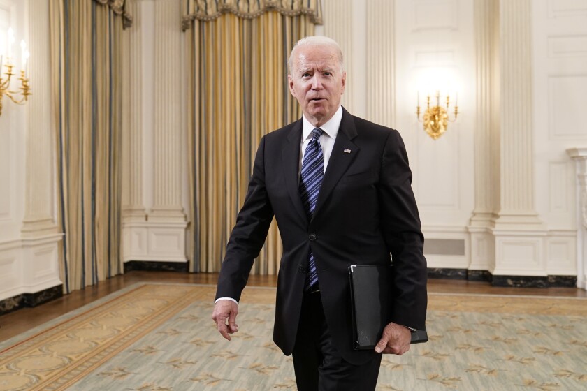 President Biden walks out of the State Dining room
