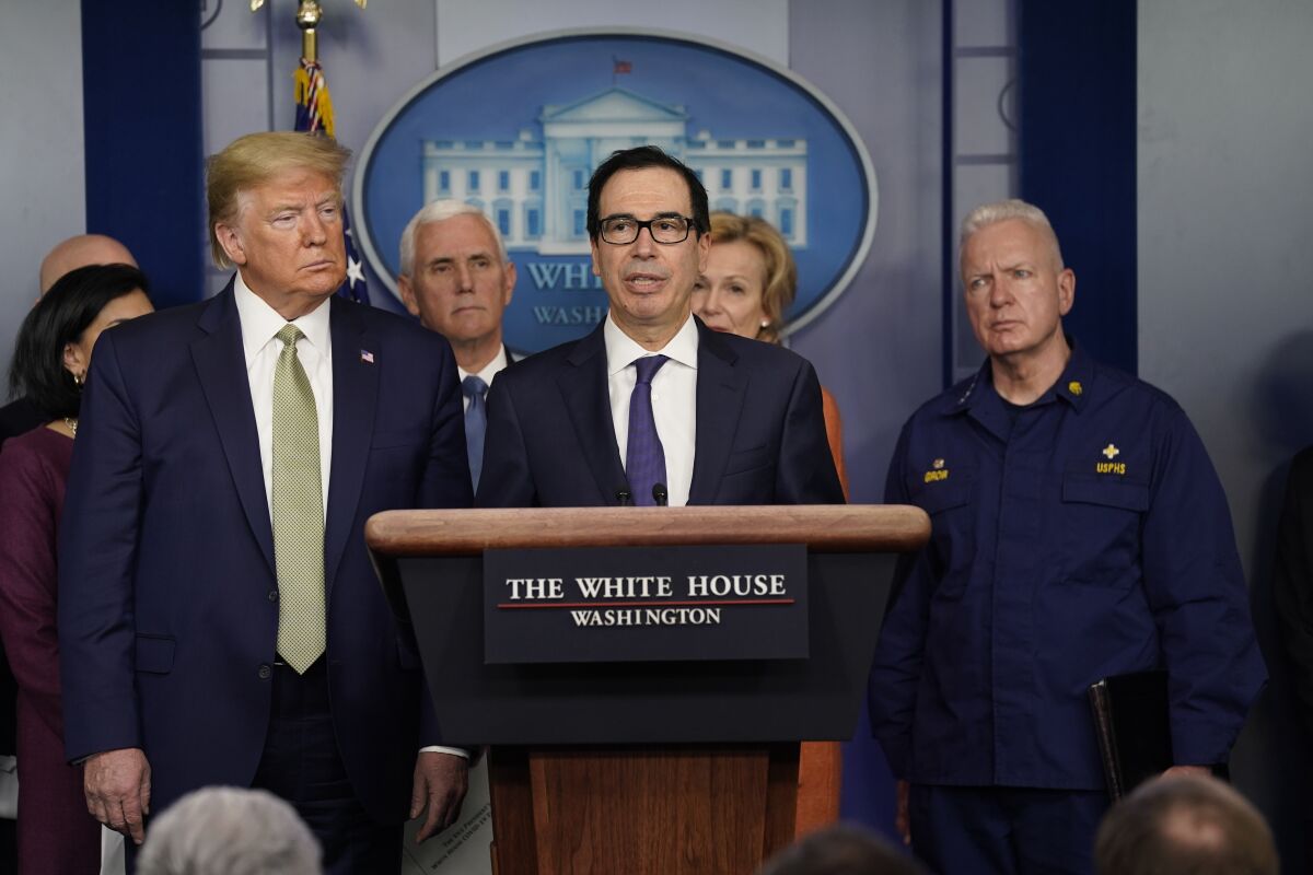 Treasury Secretary Steven Mnuchin, center, speaks during a news briefing with the coronavirus task force at the White House on Tuesday.
