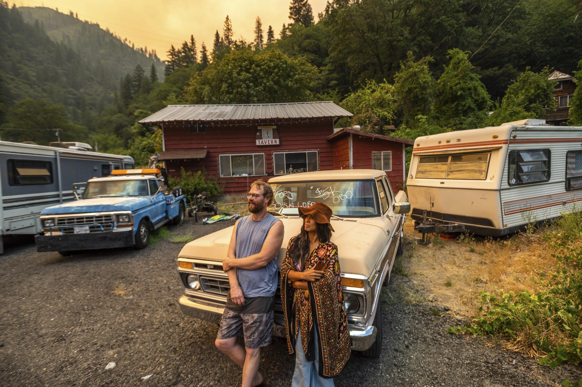 Jessica and Benjamin Bell watch as the Dixie fire burns along Highway 70 in Plumas National Forest.