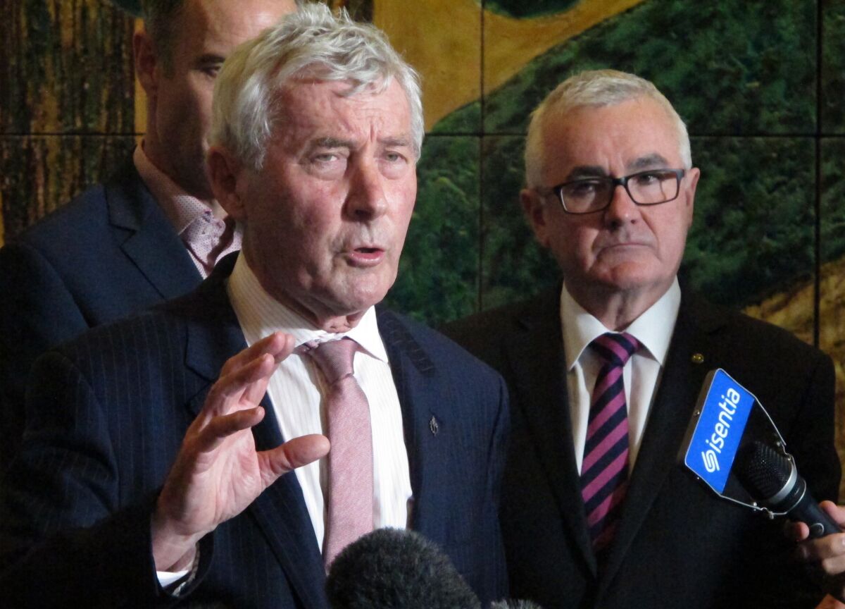 FILE - In this June 28, 2018, file photo lawyer Bernard Collaery, left, addresses the media in Parliament House in Canberra, Australia. A court agreed Wednesday, Oct. 6, 2021, to lift a shroud of secrecy from the trial of a spy's lawyer Collaery that could potentially confirm that Australia bugged East Timor's government during multibillion-dollar oil and gas negotiations. (AP Photo/Rod McGuirk, FILE)