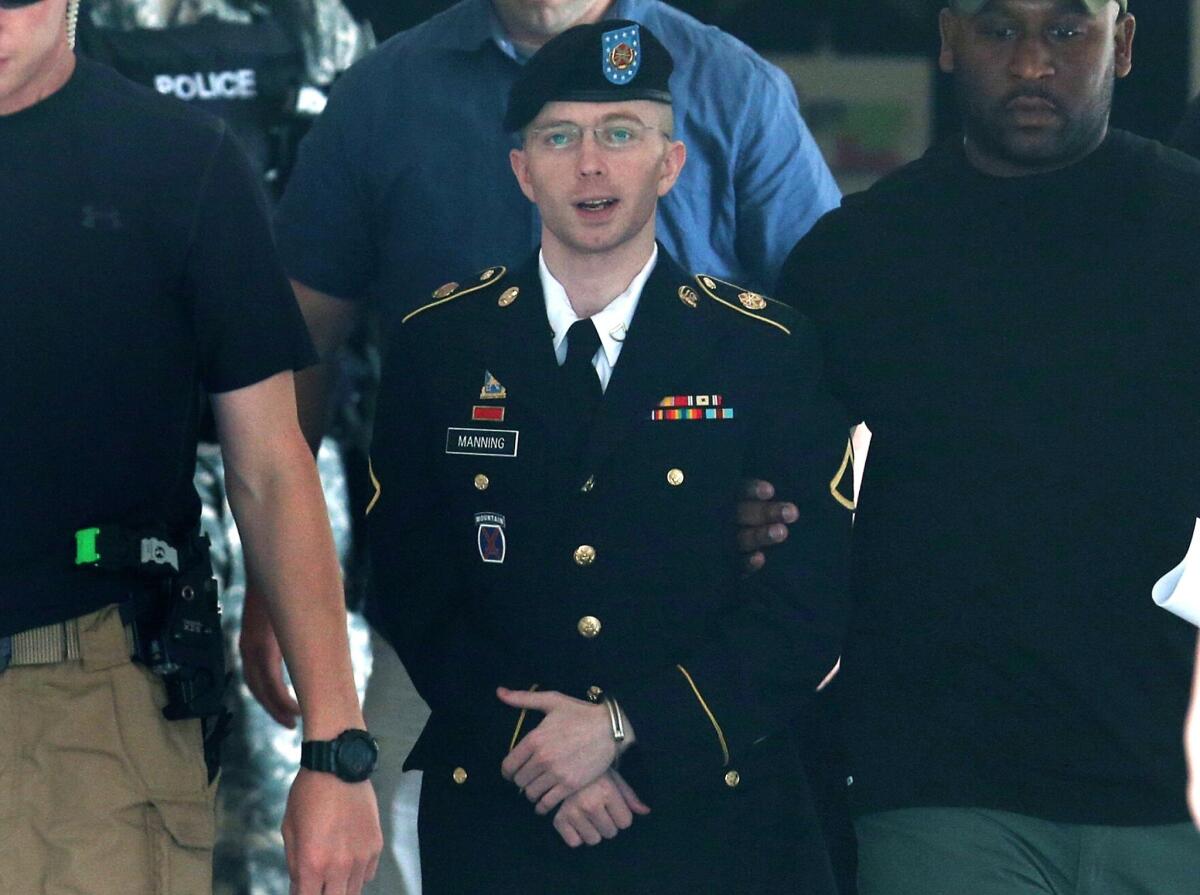 Army Pfc. Bradley Manning is escorted by military police as he leaves his military trial after he was acquitted of aiding the enemy but convicted of other charges.