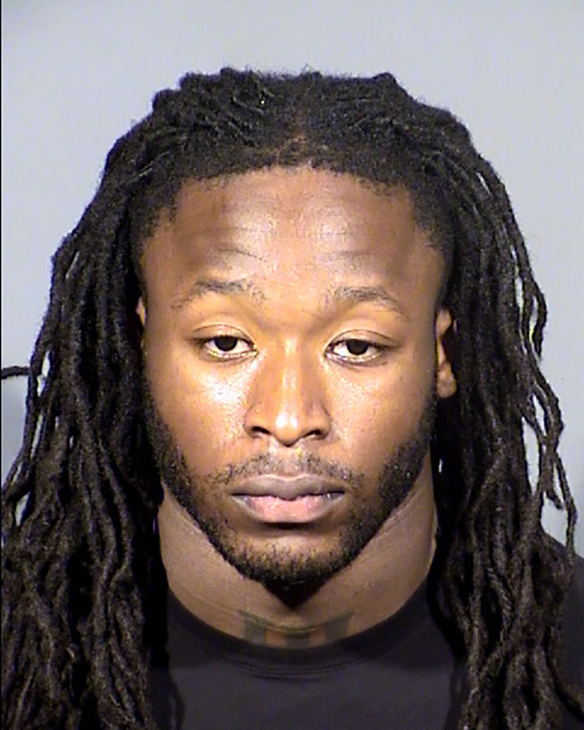 FILE - This Clark County, Nev., Detention Center booking photo shows New Orleans Saints running back Alvin Kamara following his arrest Sunday, Feb. 6, 2022, in Las Vegas on a felony battery charge. A judge in Las Vegas postponed until next month a hearing in an assault case involving two NFL players and two other men accused of severely beating a man at a Las Vegas Strip nightclub the weekend of the Pro Bowl. Kamara and Kansas City Chiefs cornerback Chris Lammons and two other defendants, Darrin Young and Percy Harris, didn't have to appear in person in court on Tuesday March 8, 2022. (Clark County Detention via AP,File)