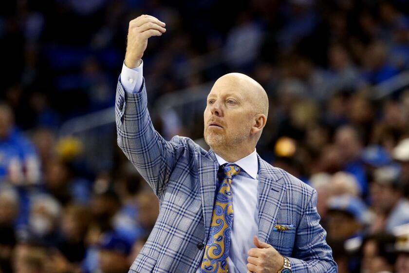 UCLA coach Mick Cronin stands on the sideline and directs his players against Arizona