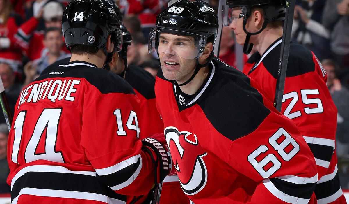Devils right wing Jaromir Jagr (68) celebrates his hat trick with teammate Adam Henrique in the second period of a game against the Flyers on Friday in Newark.