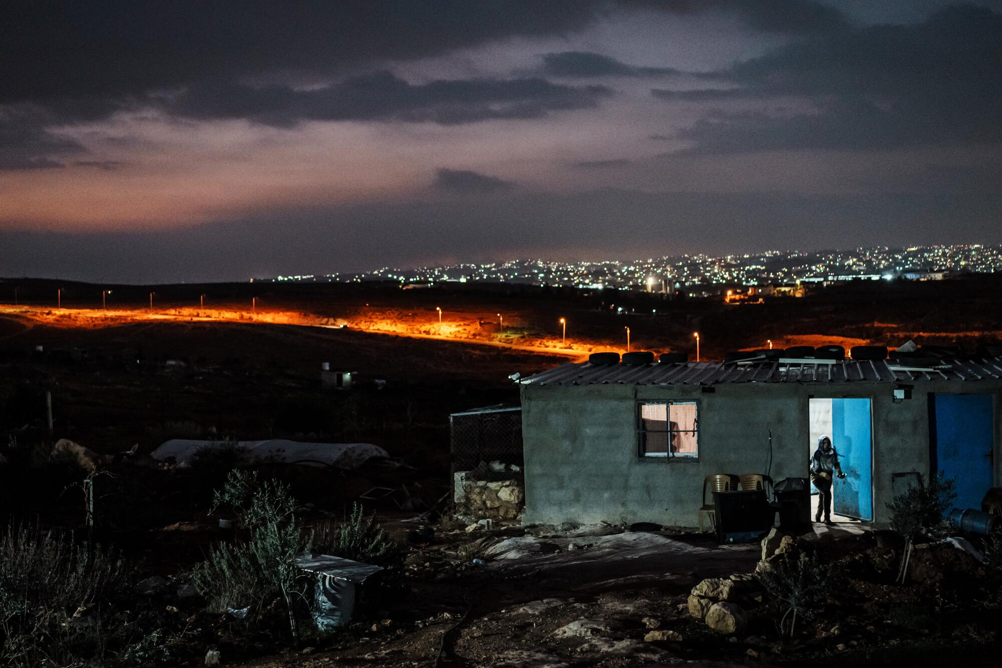 Route 317 is illuminated with street lights, as seen from the Palestinian village Shaeb Al-Botum