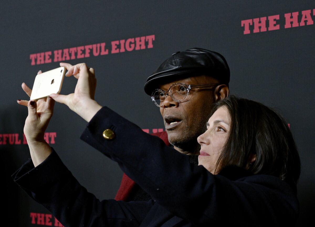Actor Samuel L. Jackson, left, poses for a picture with producer Stacey Sher as they attend the premiere of 'The Hateful Eight' at ArcLight Cinemas Cinerama Dome in Hollywood.