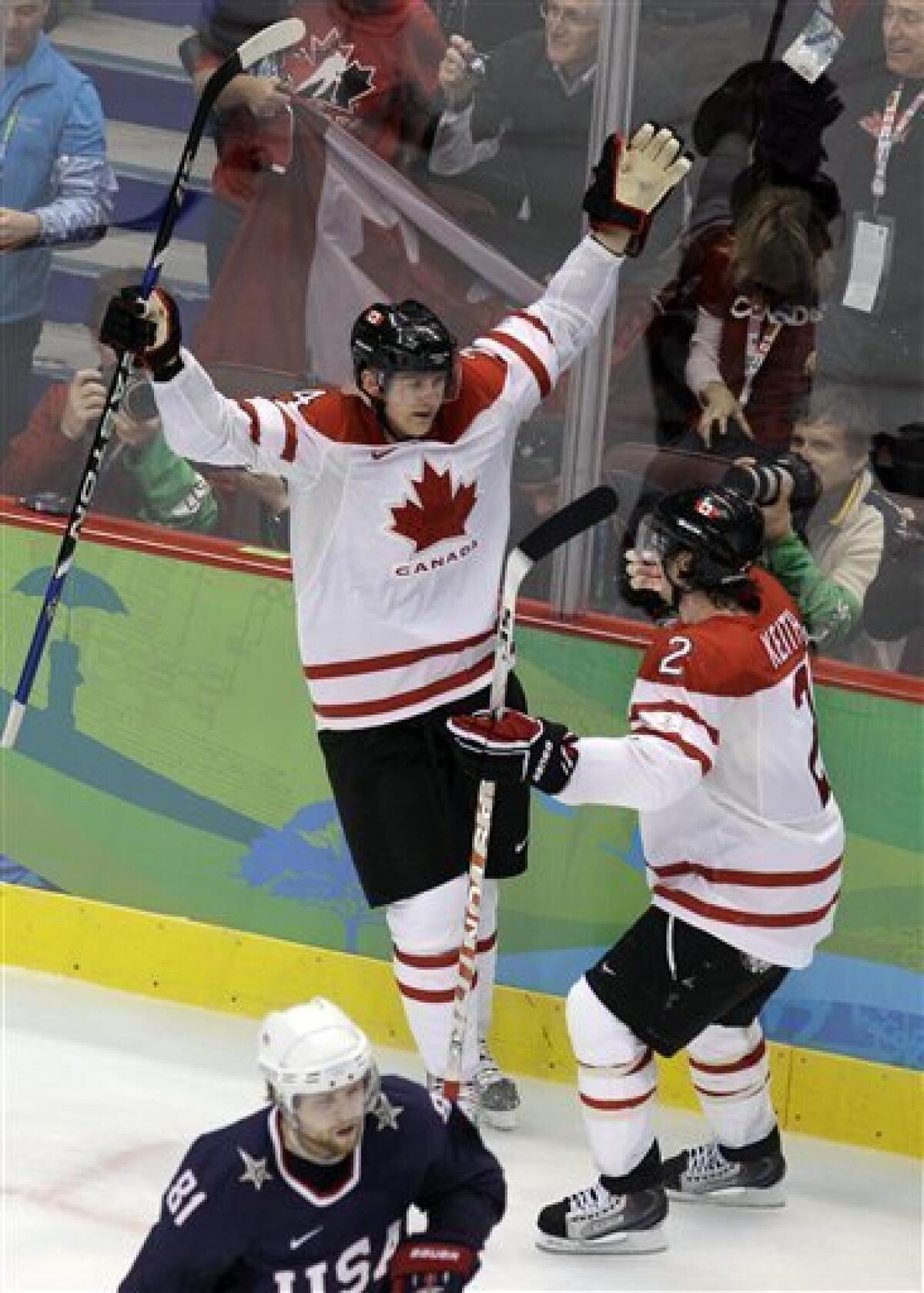 Team Canada captain Scott Niedermayer skates with the flag after