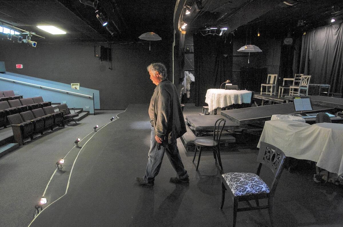 Mike Brown, president of the Costa Mesa Playhouse, walks the playhouse's stage at Rea Elementary School in Costa Mesa on Tuesday. The Newport-Mesa Unified School District has told the playhouse it must leave the campus to make way for a technology learning center.