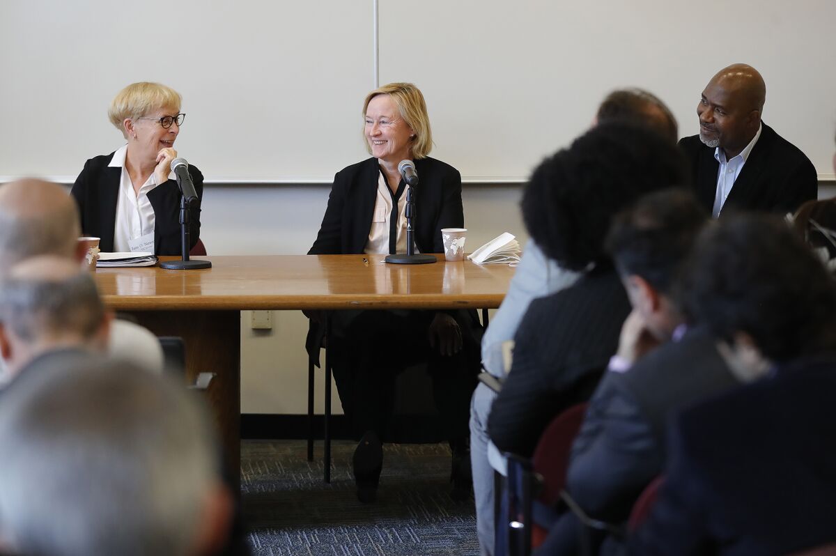 Jane Newman, left, Anne McCall and Alfred Babo, participate Thursday in a conference at UC Irvine titled "Refuge at Risk."