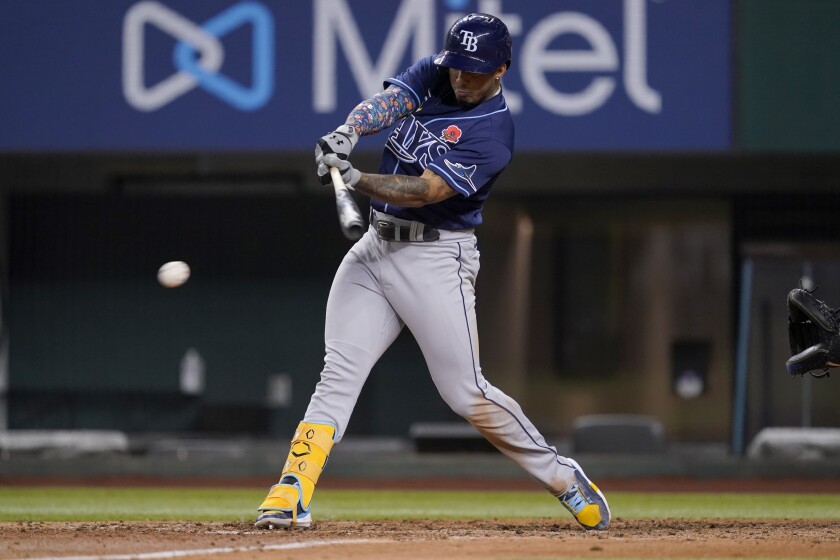 Tampa Bay Rays' Wander Franco connects for a run-scoring single in the fifth inning of a baseball game against the Texas Rangers, Monday, May 30, 2022, in Arlington, Texas. Kevin Kiermaier scored on the play. (AP Photo/Tony Gutierrez)