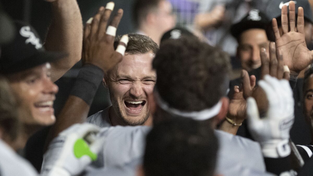 Chicago White Sox Adam Engel, center, celebrates in the dugout after hitting a three-run home run against the Minnesota Twins during the during the seventh inning of a baseball game Friday, July 15, 2022, in Minneapolis.(AP Photo/Craig Lassig)