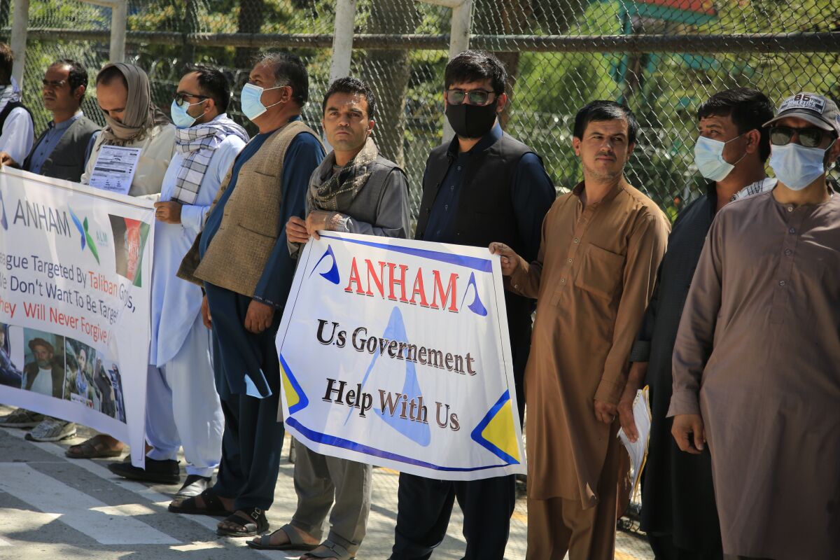 Former workers who had been employed with U.S. troops in Afghanistan hold placards during a demonstration.
